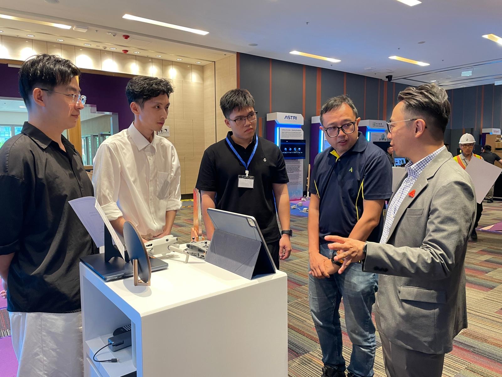 CIC AI Award booth discussion around the SRR exhibit